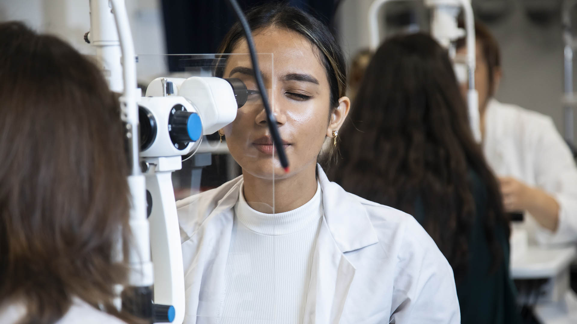 Optometry students performing eye tests in ARU's University Eye Clinic