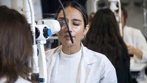 Optometry students performing eye tests in ARU's University Eye Clinic