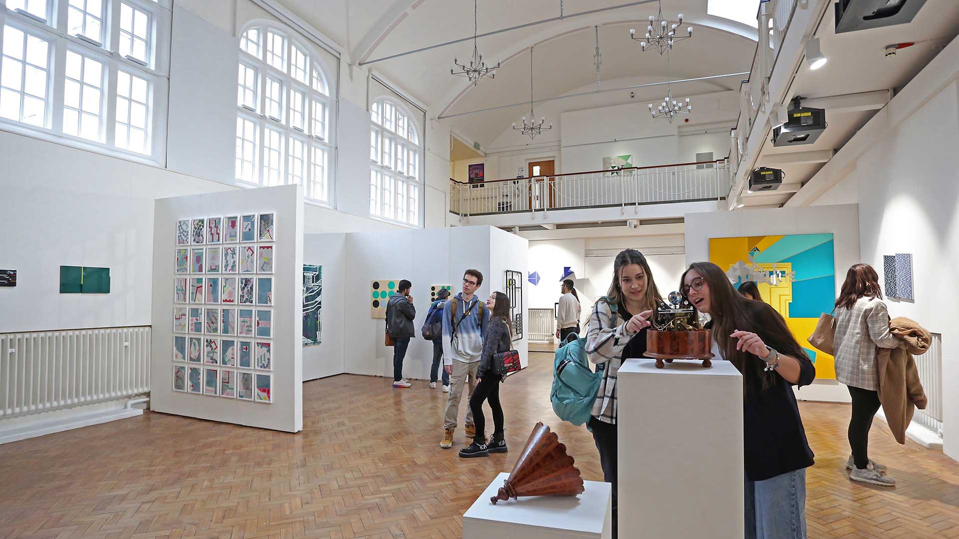 People looking at artwork in the Ruskin Gallery on ARU's Cambridge campus