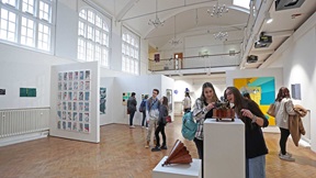 People looking at artwork in the Ruskin Gallery on ARU's Cambridge campus