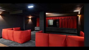 Sofas facing a TV in a darkened room, in Cambridge's CB1 accommodation