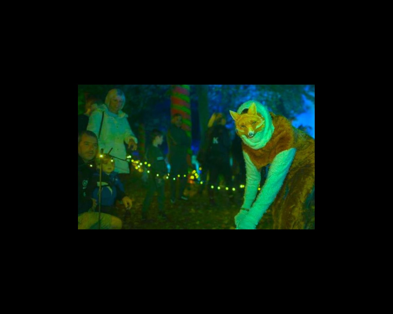 Actor in fox costume with audience watching