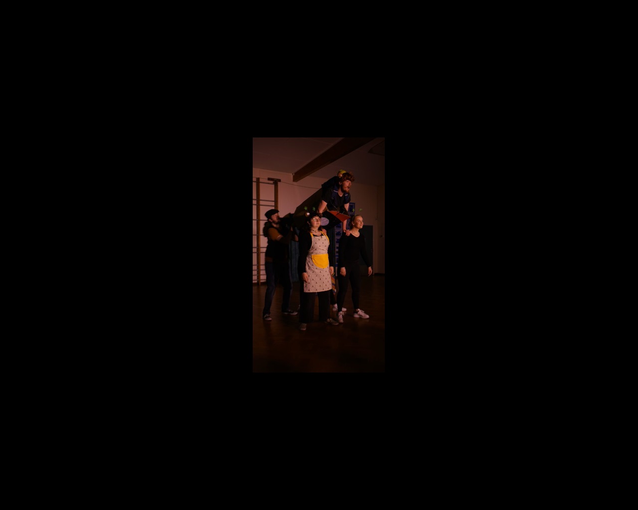 Student held aloft by four others on stage