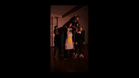 Student held aloft by four others on stage