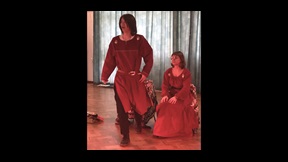 Two drama students in red Chinese-style costumes rehearsing a play