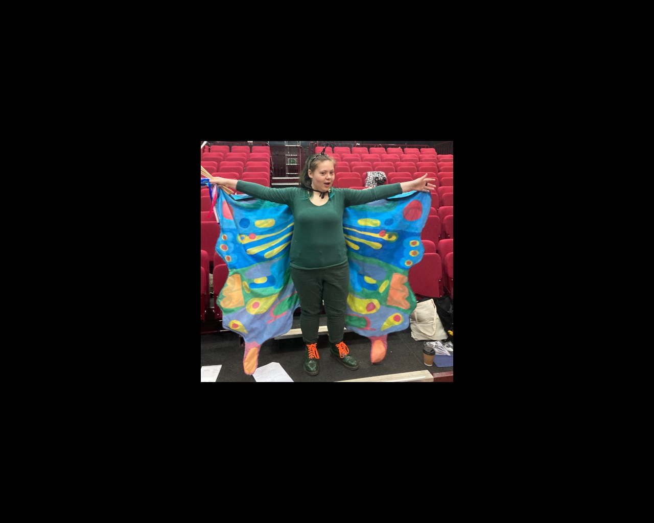 Female student wearing butterfly wings