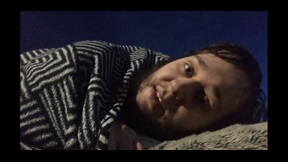 Film still of man lying in bed