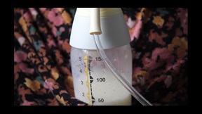 Film still of baby bottle filled with milk