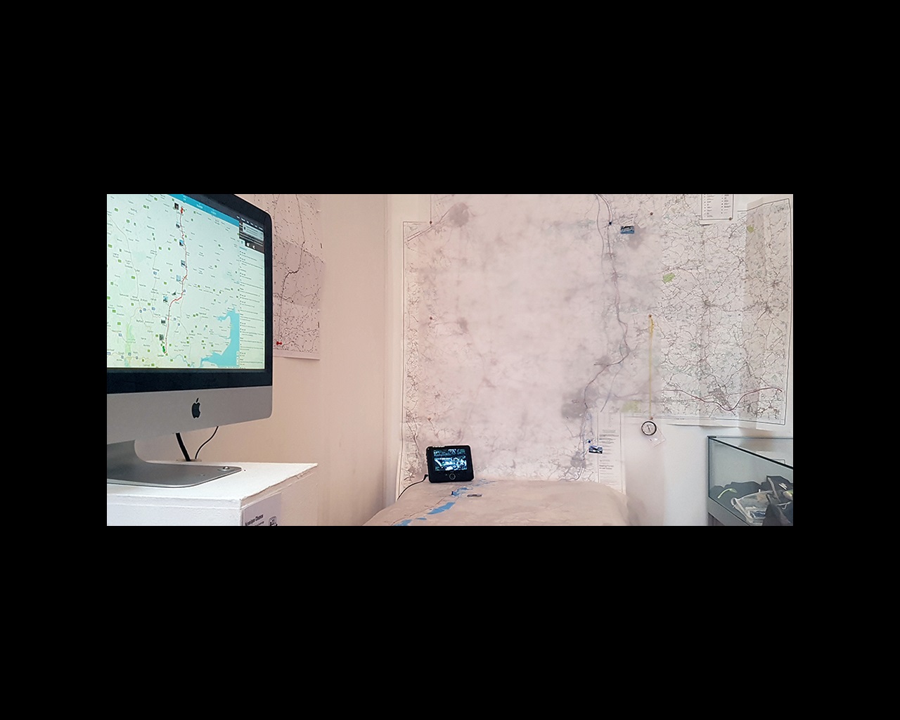 Photo of map on screen and wall from Veronique Chance's London to Cambridge Run Commute
