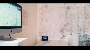 Photo of map on screen and wall from Veronique Chance's London to Cambridge Run Commute
