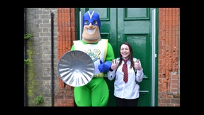 Michael the Recycling Superhero in costume with student actor Laura Mackay