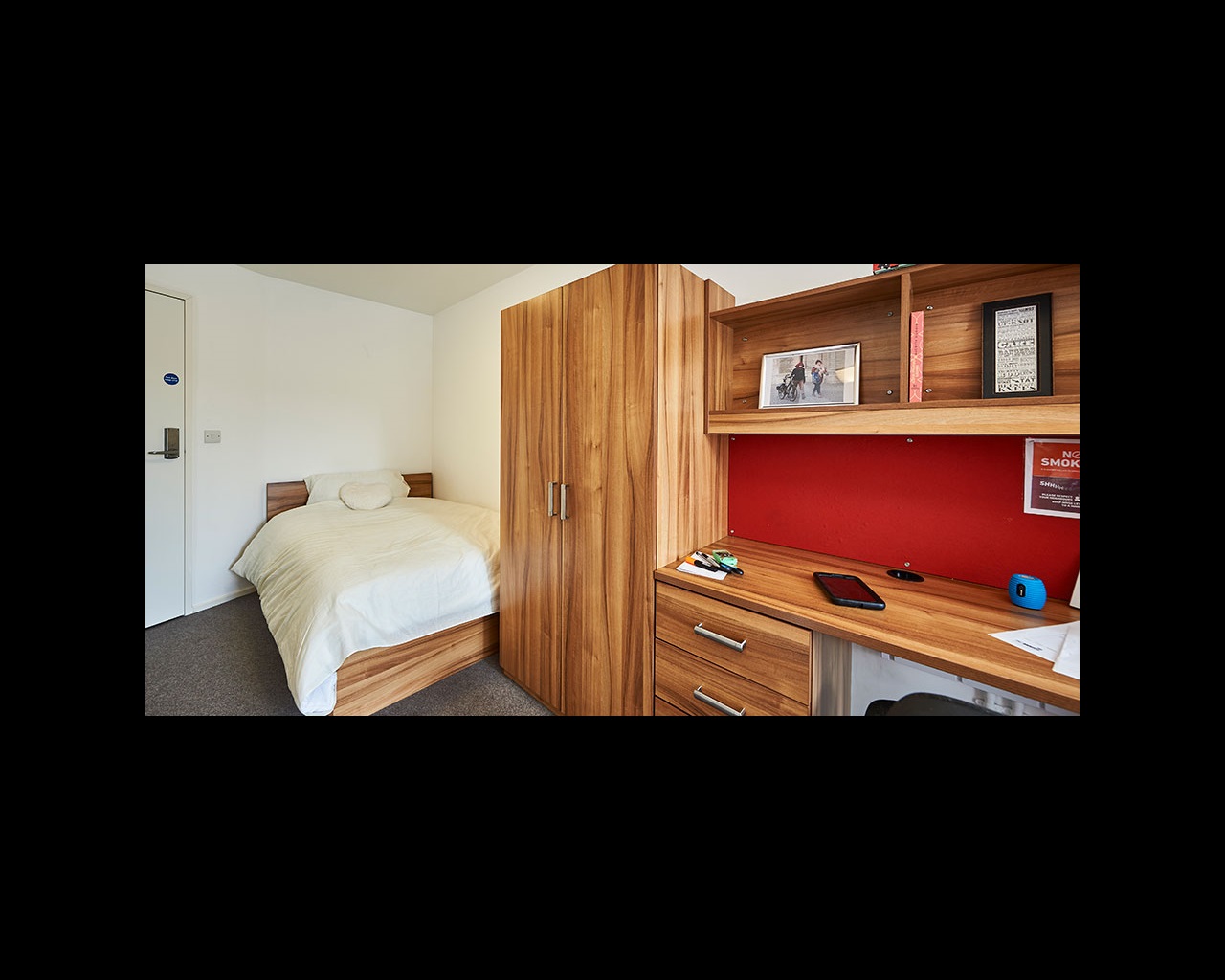 Bedroom with storage units and desk space