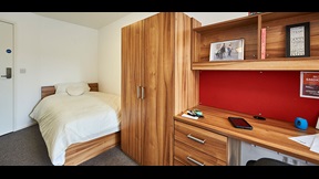 Bedroom with storage units and desk space