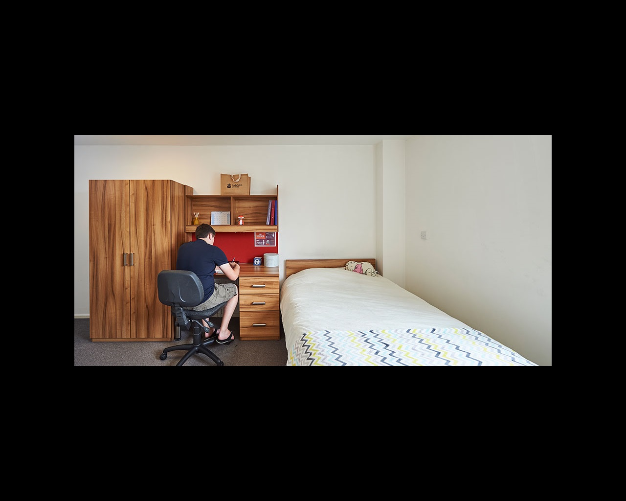 Student working at desk space in bedroom