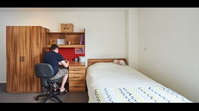 Student working at desk space in bedroom