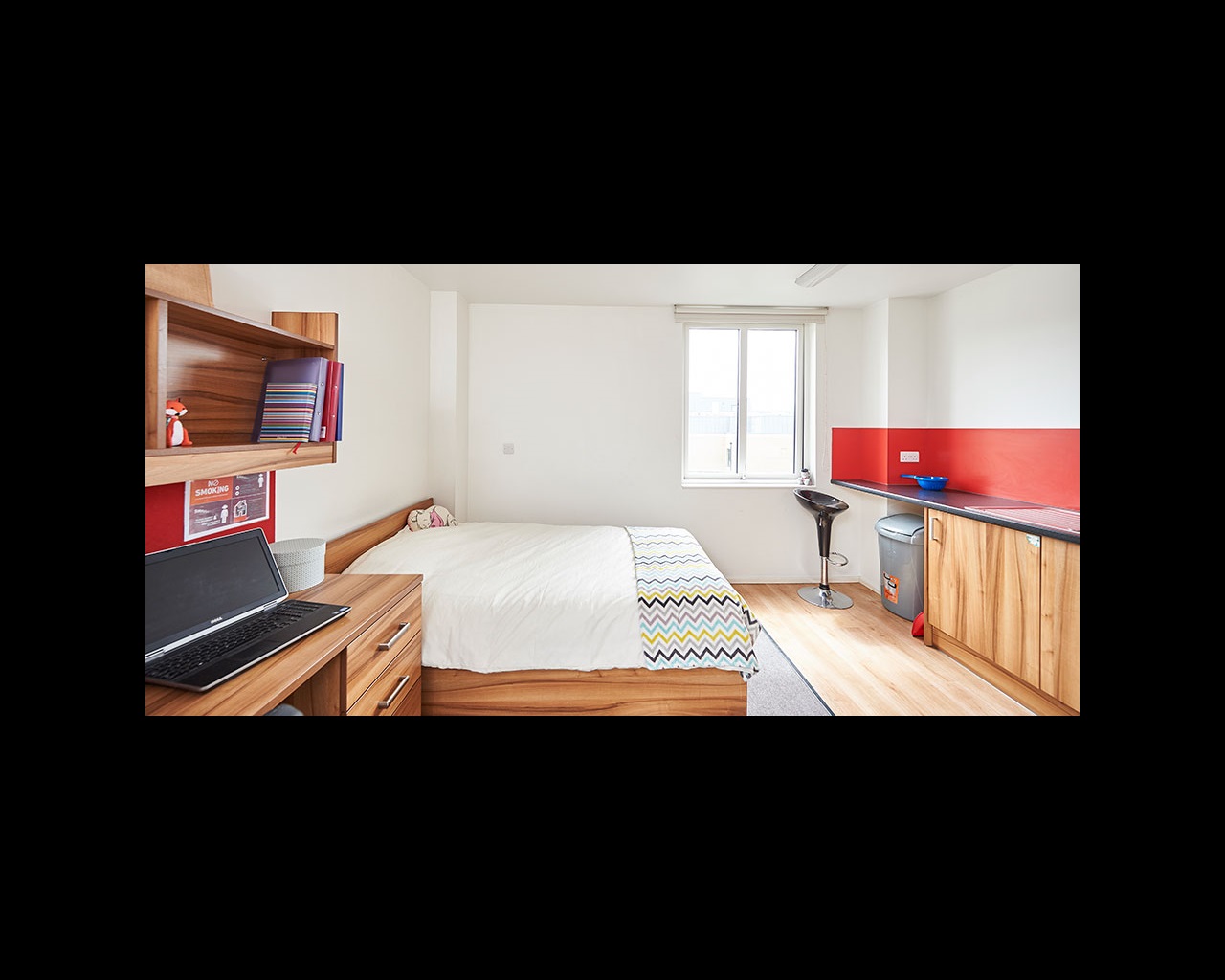 Studio apartment with bed, kitchenette area and study space