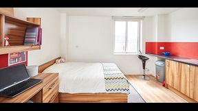 Studio apartment with bed, kitchenette area and study space