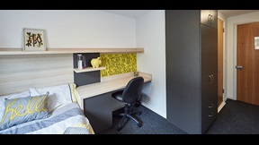 Bedroom with desk space and storage