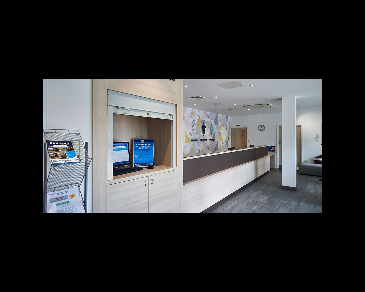 Reception area with desk, brochures and computer