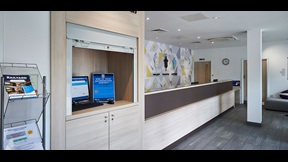 Reception area with desk, brochures and computer