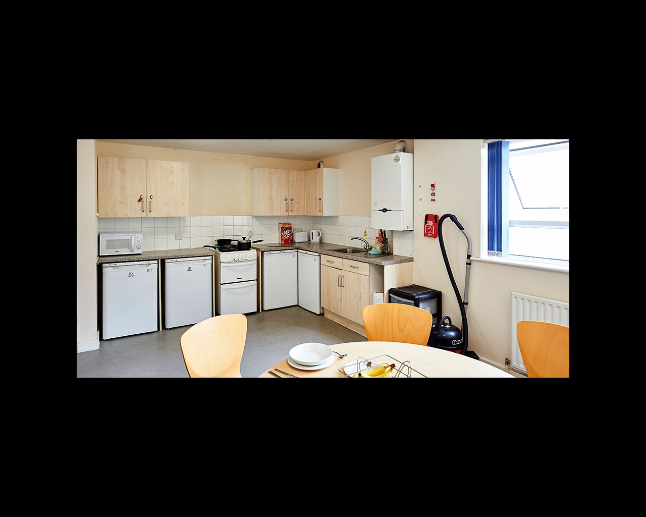 Kitchen with dining table and chairs in the foreground