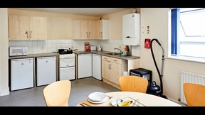 Kitchen with dining table and chairs in the foreground