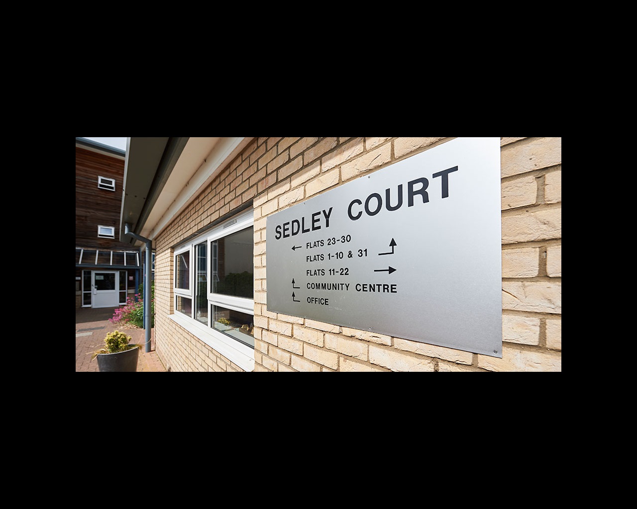 Exterior sign for Sedley Court with flat numbers
