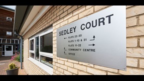 Exterior sign for Sedley Court with flat numbers