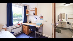 Bedroom with door into adapted bathroom