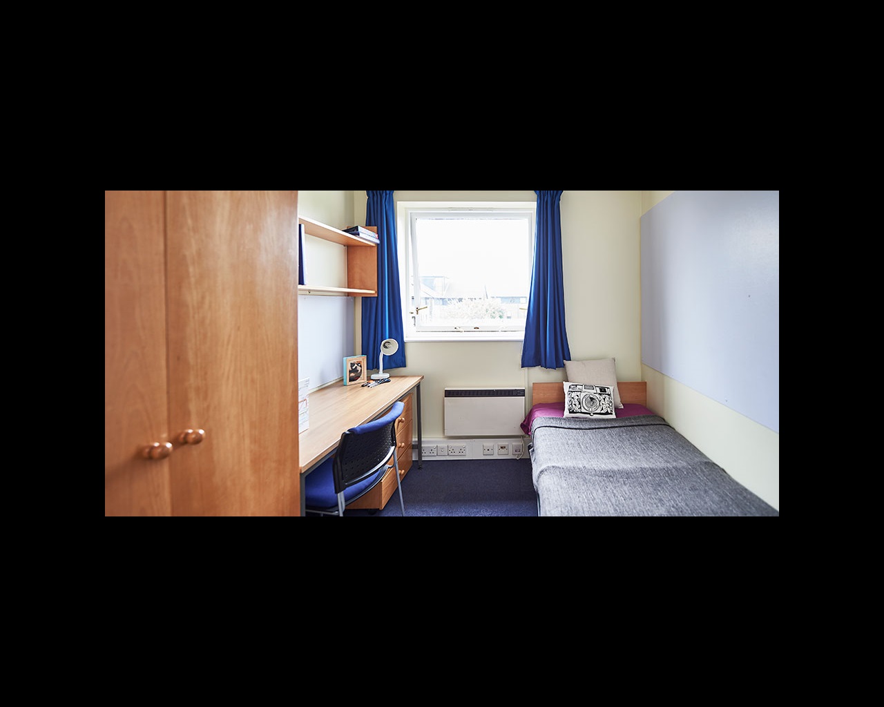 Bedroom with desk and bookshelf
