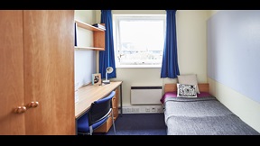 Bedroom with desk and bookshelf