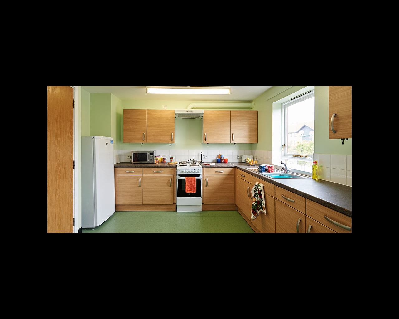 Kitchen with fitted units, fridge freezer and oven