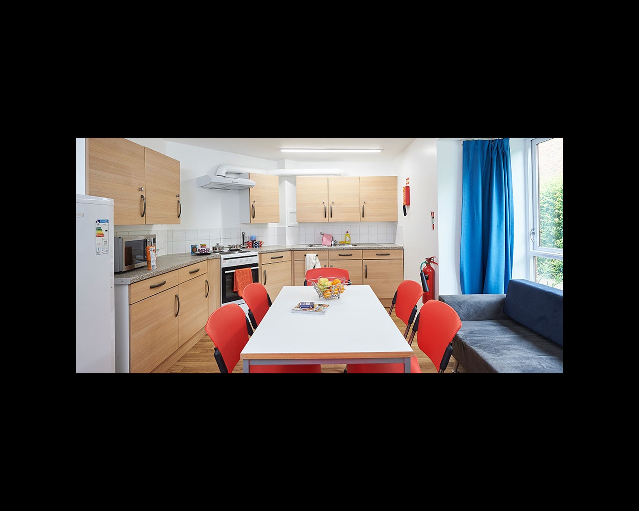 Kitchen with fitted units, fridge freezer, oven and dining table