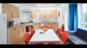 Kitchen with fitted units, fridge freezer, oven and dining table