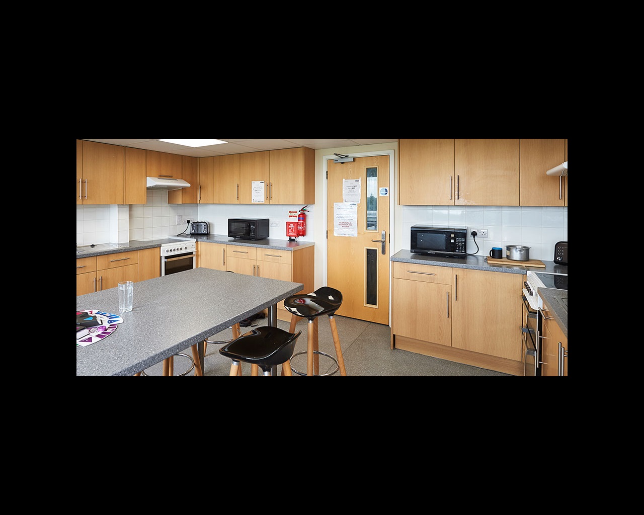 Kitchen with bar stools and built-in table