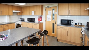 Kitchen with bar stools and built-in table