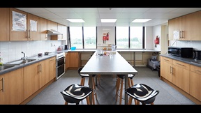 Kitchen with bar stools and built-in table